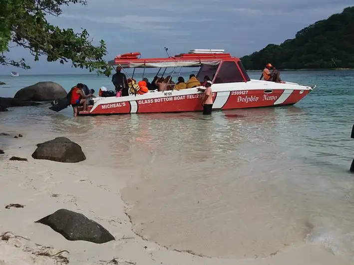 The original red-and-white Dolphin Nemo boat at a Seychelles beach
